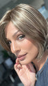 Model is wearing AVA by JON RENAU in color 10RH16 CAFFE MOCHA | Light Brown with 33% Light Natural Blonde Highlights