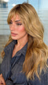 Roxie wearing POSH WAVEZ by RENE OF PARIS in Bronzed Honey-R | A perfect blend of rich, warm golden blond and medium chocolate brown tones, complemented by a dark chocolate root that adds a luxurious, dimensional effect.