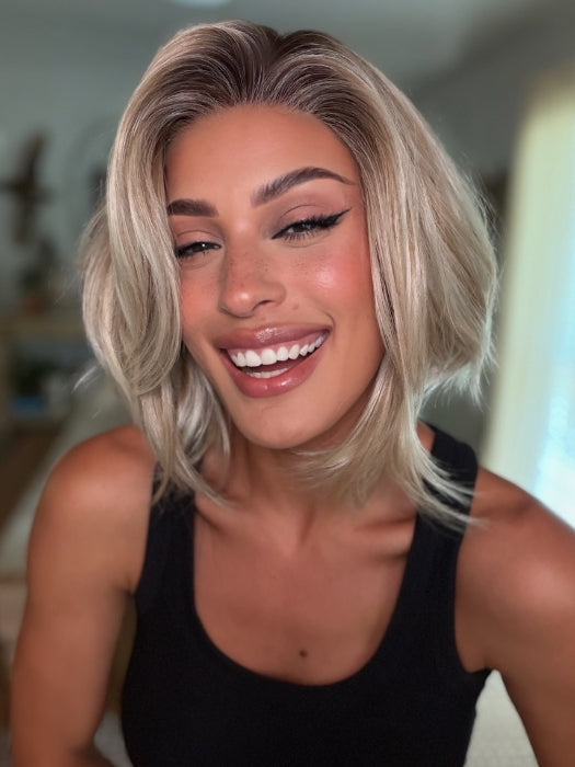 Roxie wearing MIRA by AMORE in SEA SALT BLOND R | A perfect mixture of cool, icy-blond and warm-dark blond. The rich brown root tone enhances the modern appearance.