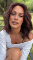 Roxie wearing SMOOTH WAVEZ by RENE OF PARIS in DUSTY-ROSE | Medium Coral Red Base with Dark Brown Roots