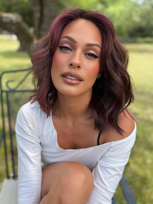 Roxie wearing SMOOTH WAVEZ by RENE OF PARIS in DUSTY-ROSE | Medium Coral Red Base with Dark Brown Roots