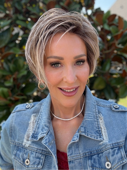 Eileen wearing SPENCER by BELLETRESS in BUTTERCAKE BLONDE-R | A neutral-warm blonde blend featuring light brown, ash, and lightest blonde tones with natural-looking darker roots for added depth and realism.