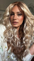 Roxie wearing PHILLIPA by RENE of PARIS in WINTER OAT LATTE R | rooted honey blonde and platinum blonde blend with soft, dimensional highlights and lowlights