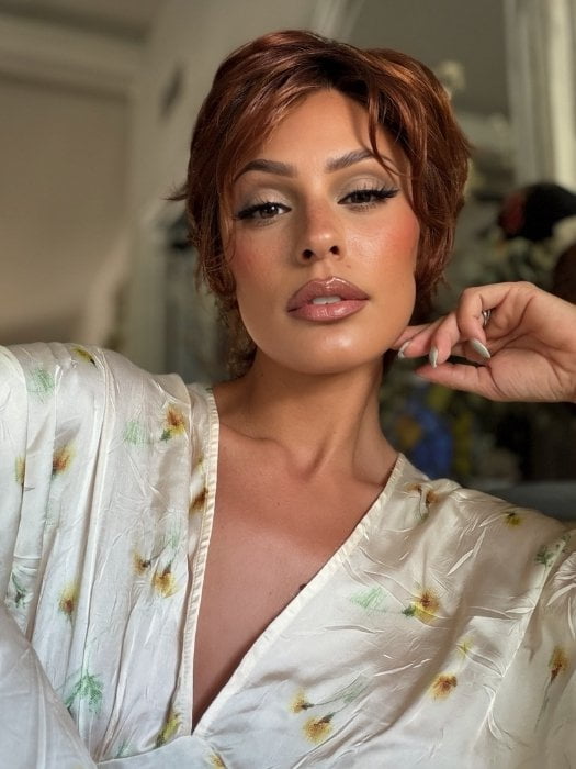 Roxie wearing ASHA by RENE OF PARIS in CAFE ROUGE R | A dimensional auburn copper blend with rich reddish-brown roots melting into warm copper highlights