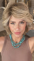 Madeline wearing MONROE by BELLETRESS in BUTTERCAKE BLONDE-R | A neutral-warm blonde blend featuring light brown, ash, and lightest blonde tones with natural-looking darker roots for added depth and realism.