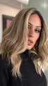 Model is wearing COREY by ENVY in color HONEY BREEZE | A blend of Cool, Honey Blonde and Multi-Dimensional Medium Brown with Darker Brown Roots