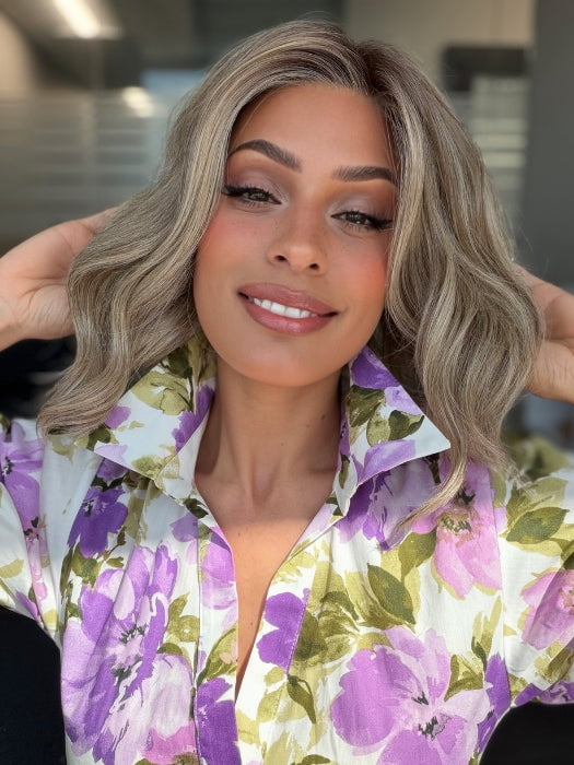 Roxie is wearing VERONICA by BELLETRESS in SPARKLING CHAMPAGNE BLONDE R | A radiant blend of champagne blonde with soft golden and beige tones, grounded by natural-looking roots in ash brown and dark blonde.