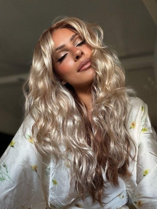 Roxie wearing PHILLIPA by RENE of PARIS in WINTER OAT LATTE R | rooted honey blonde and platinum blonde blend with soft, dimensional highlights and lowlights