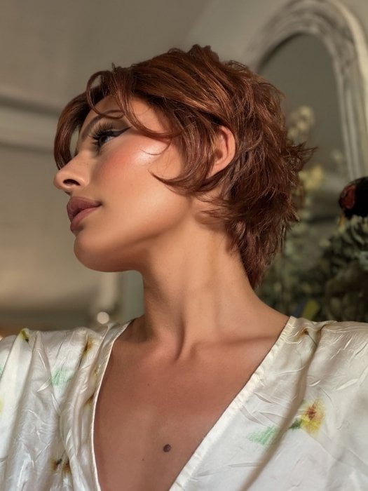 Roxie wearing ASHA by RENE OF PARIS in CAFE ROUGE R | A dimensional auburn copper blend with rich reddish-brown roots melting into warm copper highlights