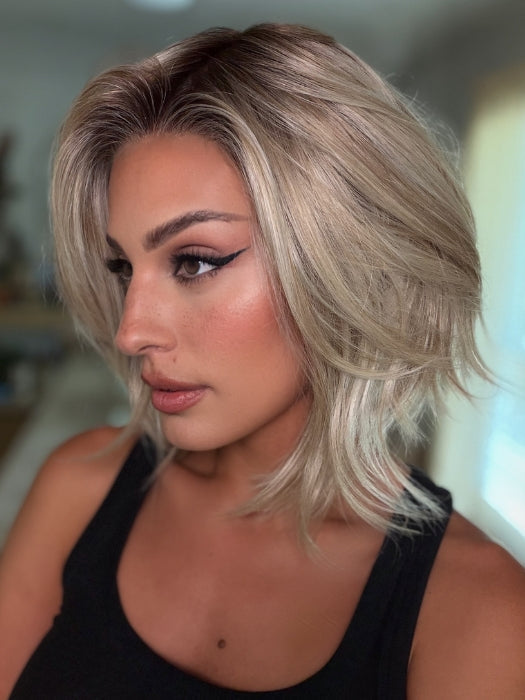 Roxie wearing MIRA by AMORE in SEA SALT BLOND R | A perfect mixture of cool, icy-blond and warm-dark blond. The rich brown root tone enhances the modern appearance.