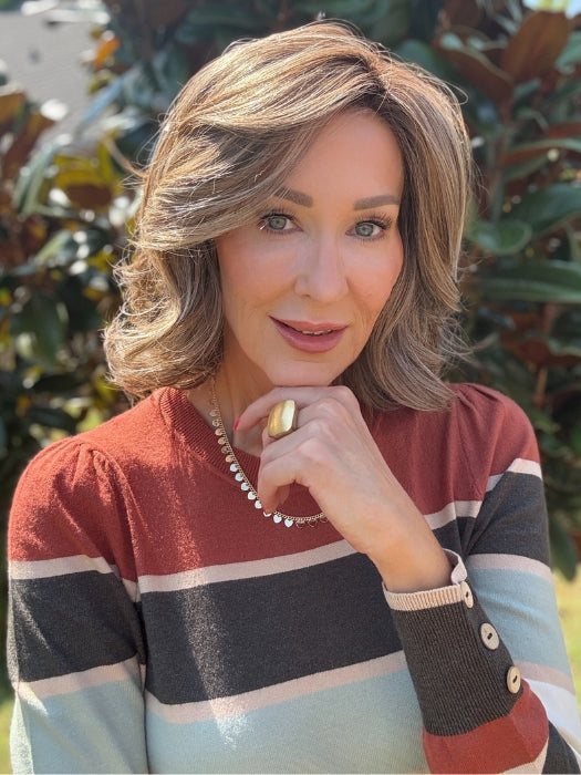 Eileen wearing HELSINKI by BELLETRESS in MACADAMIA LATTE R | A combination of Medium and Light Brown, highlighted with Light Gold Blonde, and a mixture of Ash Blonde and Light Gold Blonde, Rooted with Medium and Light Brown