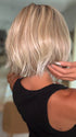 Roxie wearing MIRA by AMORE in SEA SALT BLOND R | A perfect mixture of cool, icy-blond and warm-dark blond. The rich brown root tone enhances the modern appearance.