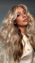 Roxie wearing PHILLIPA by RENE of PARIS in WINTER OAT LATTE R | rooted honey blonde and platinum blonde blend with soft, dimensional highlights and lowlights