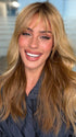 Roxie wearing POSH WAVEZ by RENE OF PARIS in Bronzed Honey-R | A perfect blend of rich, warm golden blond and medium chocolate brown tones, complemented by a dark chocolate root that adds a luxurious, dimensional effect.