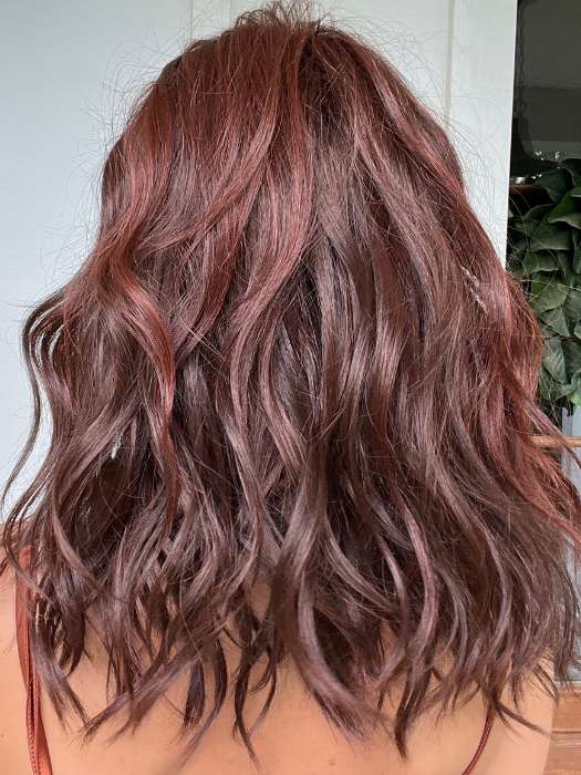 Jenna Fail @jenna_fail wearing BEACH WAVE MAGIC by TRESSALLURE in color 10/130R | Bright Red with Medium Brown roots