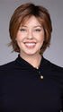 Model is wearing MIXED BERRY R | A bold, berry-inspired red with deep auburn tones and soft rooting for a natural regrowth effect.