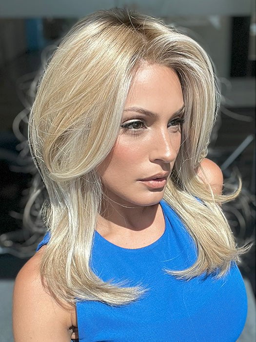 Model is wearing ALASIA by ELLEN WILLE in color BAHAMA BEIGE SHADED 22.16.26 | Medium Honey Blonde, Lightest Ash Blonde, and Lightest Reddish-Brown Blend with Medium Shaded Roots