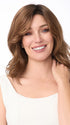 Model is wearing AMANDA by ENVY in color CINNAMON TOFFEE | Neutral to Warm Light Brown with Dark Brown Roots