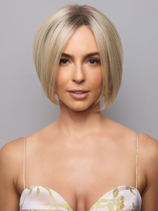 Model is wearing AYUMI by NORIKO in color Light Ash Blond R | Cream Ash Blonde with ash brown and white-grey roots that blend into a variety of ash blonde tones, including ash pearl blonde, creamy ivory, and pale cream