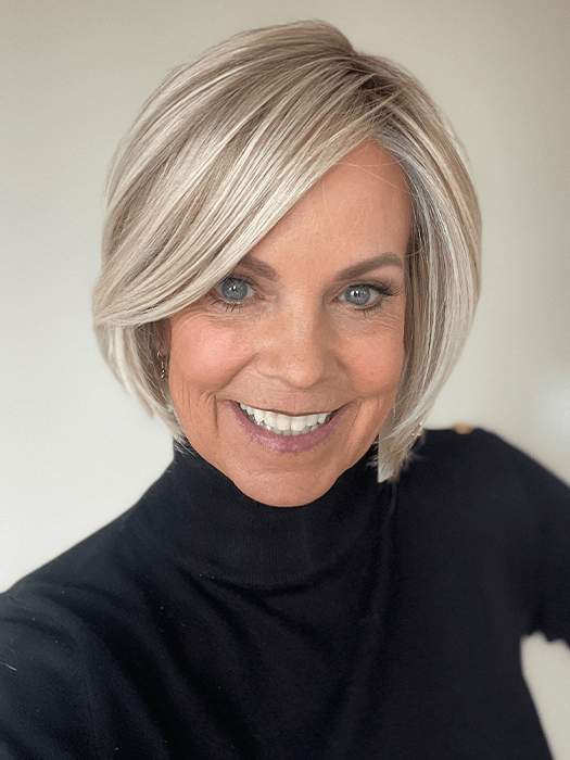 Susan Sparks @sparkles_intheworld wearing STRAIGHT UP WITH A TWIST by RAQUEL WELCH WIGS in color SS19/23 SHADED BISCUIT | Cool Platinum blonde with subtle highlights and medium brown roots