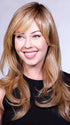  A long, layered hairstyle with soft curls, and long, wispy bangs