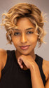 Model is wearing Twisted Pixie by TressAllure in shade EL17/23/R8 | Pale Auburn Beige Blonde Blend, Rooted Medium Brown, Highlighted Light Blonde with face framing highlights