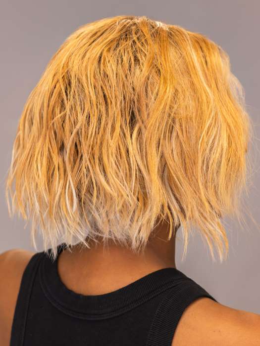 Model is wearing ROSANNA by RENE OF PARIS in shade PEACHES-AND-CREAM | A vibrant peach blonde with creamy undertones and bright, face-framing cream highlights. Rich chocolate root adds depth.