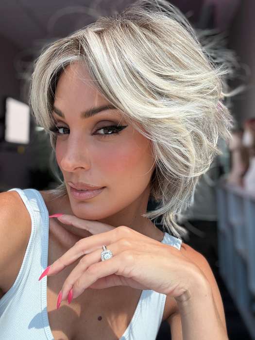 Model is wearing MAIN CHARACTER by RAQUEL WELCH in color RL17/23SS ICED LATTE MACCHIATO | Honey Blonde shaded with Cool Blonde and Dark Roots