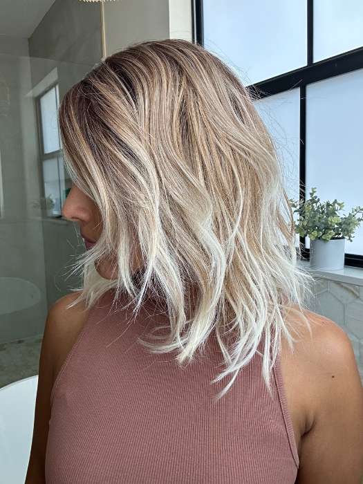 Lorena @faux.hurr.lifee wearing DAZZLING WAVEZ by RENE OF PARIS in shade MELTED MARSHMALLOW | Subtly Warm Dark Sandy Blonde Blend with Medium Brown Roots and Light Ash Blonde Tips and Highlights