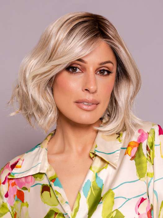 Model is wearing MIRA by AMORE in color SEA SALT BLOND R | A perfect mixture of cool, icy-blond and warm-dark blond. The rich brown root tone enhances the modern appearance.    