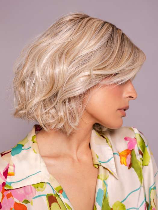 Model is wearing MIRA by AMORE in color SEA SALT BLOND R | A perfect mixture of cool, icy-blond and warm-dark blond. The rich brown root tone enhances the modern appearance.    