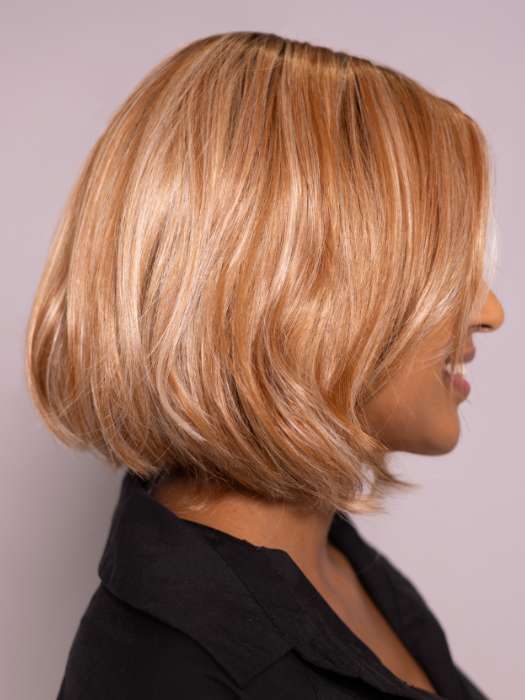 Model is wearing MIRA by AMORE in color CINNAMON FROST R | Warm, medium coppery-brown base with white-blond highlights. The medium brown root color adds a realistic vibe.   