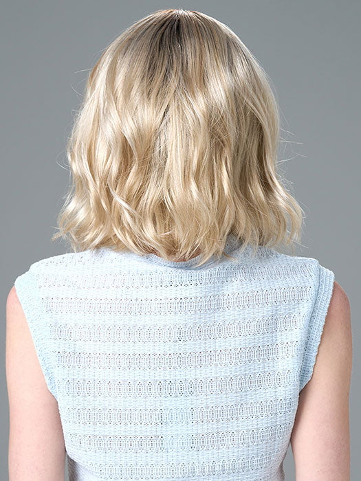 Model is wearing Charlotte Petite by ENVY in color SILKY BEIGE |  Light Platinum Blonde with Dark Brown Roots