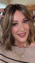 Eileen @crazywiglady is wearing CHARLOTTE PETITE  by ENVY  in color HONEY BREEZE | A blend of Cool, Honey Blonde and Multi-Dimensional Medium Brown with Darker Brown Roots