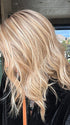 Jenny B. @thewiggygirl wearing COREY by ENVY in color SPARKLING CHAMPAGNE | Medium Brown roots with overall Strawberry Blonde base and soft Golden Blonde highlights