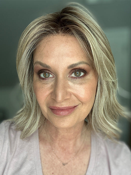 Emily H. @she_sheds_more wearing CYRUS by BELLE TRESS in color BUTTERCAKE BLONDE-R | A neutral-warm blonde blend featuring light brown, ash, and lightest blonde tones with natural-looking darker roots for added depth and realism.