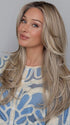 Heather @cjswigs wearing FEATURE LENGTH by RAQUEL WELCH in color RL19/23SS SHADED BISCUIT | Light Ash Blonde Evenly Blended with Cool Platinum Blonde with Dark Roots
