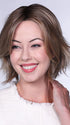 Model is wearing FERRARI By BELLETRESS in color SUNKISSED ALMOND R | A blend of Medium and Light Brown with Light Gold Blonde Highlights and a hint of Cooler Blonde, rooted with Medium and Light Brown