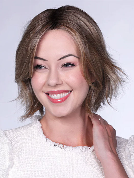 Model is wearing FERRARI By BELLETRESS in color SUNKISSED ALMOND R | A blend of Medium and Light Brown with Light Gold Blonde Highlights and a hint of Cooler Blonde, rooted with Medium and Light Brown
