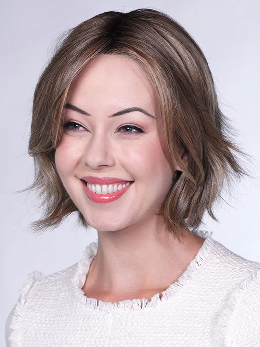 Model is wearing FERRARI By BELLETRESS in color SUNKISSED ALMOND R | A blend of Medium and Light Brown with Light Gold Blonde Highlights and a hint of Cooler Blonde, rooted with Medium and Light Brown