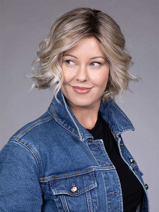 Model is wearing HOUSTON in color MILKSHAKE BLONDE R | A mixture of Light Sandy Brown, Highlighted with Light Ash Blonde with a Hint of Light Platinum Blonde with a Medium Root Color