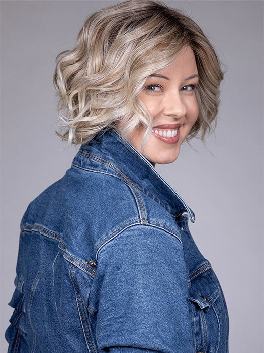 Model is wearing HOUSTON in color MILKSHAKE BLONDE R | A mixture of Light Sandy Brown, Highlighted with Light Ash Blonde with a Hint of Light Platinum Blonde with a Medium Root Color