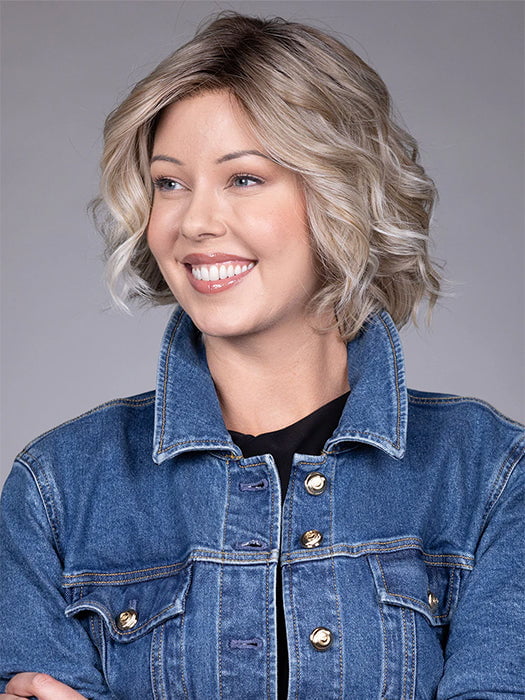 Model is wearing HOUSTON in color MILKSHAKE BLONDE R | A mixture of Light Sandy Brown, Highlighted with Light Ash Blonde with a Hint of Light Platinum Blonde with a Medium Root Color