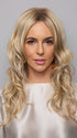 Model is wearing HANA by NORIKO in color Light Ash Blond R | Cream Ash Blonde with ash brown and white-grey roots that blend into a variety of ash blonde tones, including ash pearl blonde, creamy ivory, and pale cream