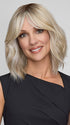 Model is wearing HOLLIE PETITE by JON RENAU in color CATALINA BLONDE 101/88/27S8 | Pale blonde with Pure White Natural Violet halo highlights, shaded medium brown