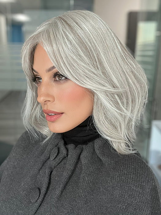 Roxie is wearing HOLLIE PETITE by JON RENAU in shade 56F51 OYSTER | Light Grey with 20% Medium Brown Front, graduating to Grey with 30% Medium Brown Nape 