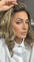 Model is wearing COREY by ENVY in color HONEY BREEZE | A blend of Cool, Honey Blonde and Multi-Dimensional Medium Brown with Darker Brown Roots