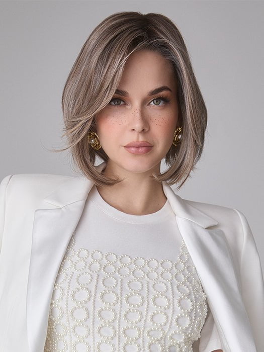 Model is wearing MIRA by AMORE in color TRES CHOCOLATE R | Carefully placed White, Medium, and Dark Chocolate tones completed with a Dark Brown Root. This color is perfect for both Blond and Brown enthusiasts.   