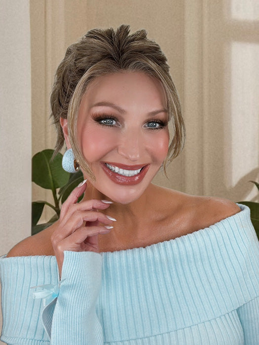 Kim Hammon @letstalkwithkim wearing KELLY by BELLE TRESS in color BROWN SUGAR BLONDE-R | A warm, dimensional blend of medium brown and golden blonde highlights with natural-looking darker roots for depth and a sun-kissed finish. (styled into bun) 