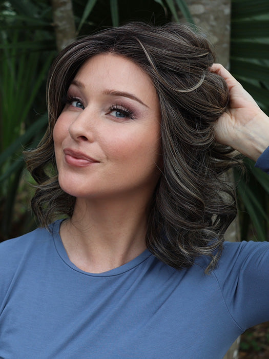 Heather @cjswigs wearing KENNEDY by BELLE TRESS in color TRUFFLE CREAM-R | A chocolate truffle-inspired medium brown base with creamy light blonde highlights and dark roots, creating a balanced, multidimensional brunette.